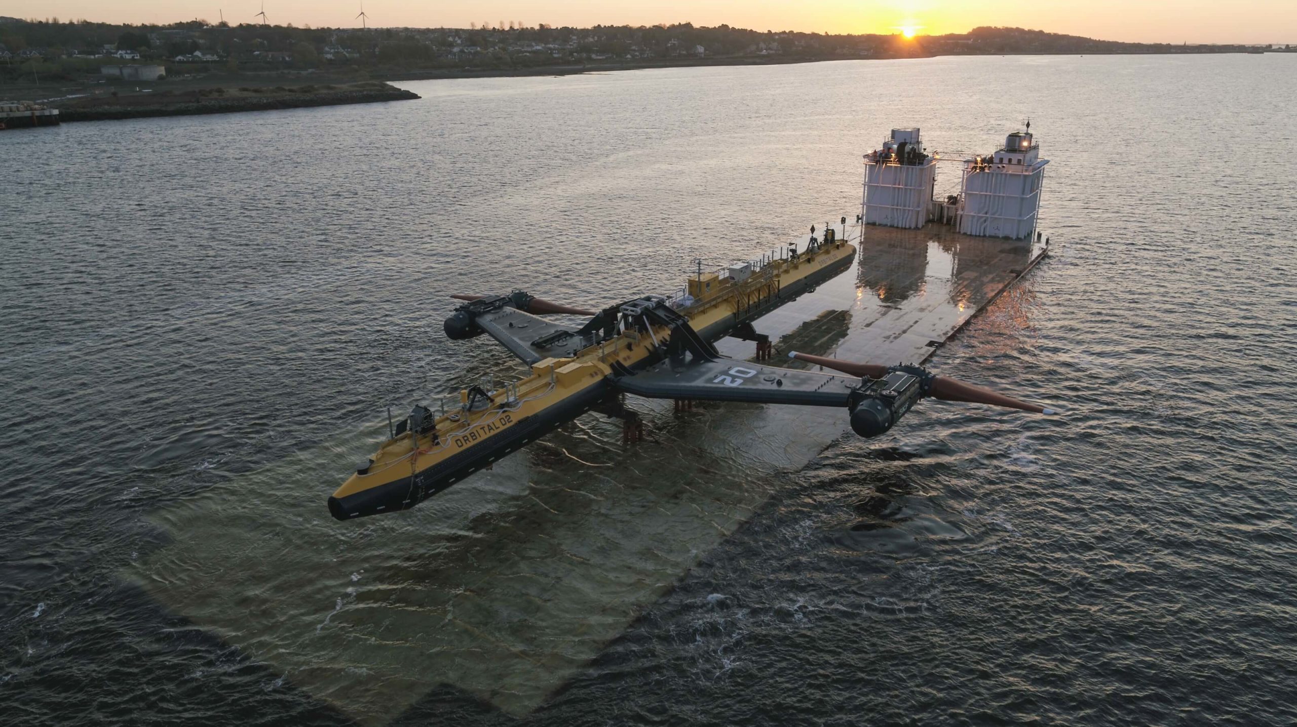 Orbital's O2 tidal turbine on a semi-submersible barge, on the River Tay, at sunset.